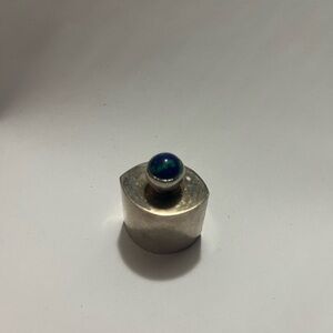 Silver vintage perfume bottle with decorative gem on top